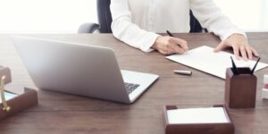 Person on desk signing papers