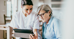 healthcare workers showing a patient results on tablet device