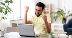 man happy looking at computer